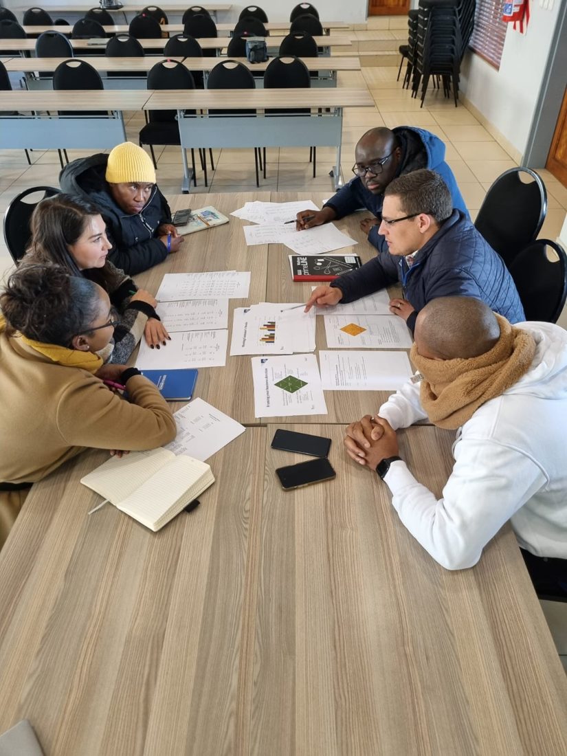 Participants analysing business simulation materials